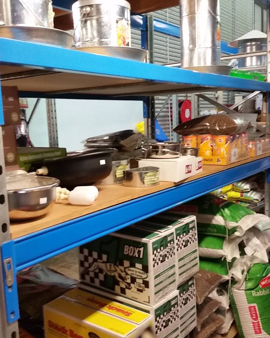 Shelves of buckets, feeders and stock supplies